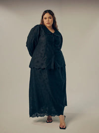 A woman dressed in All Black Tun Habiba Eyelet Set