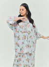 A woman dressed in Baby Blue Lily The Vintage Opah Kurung