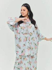 A woman dressed in Baby Blue Lily The Vintage Opah Kurung