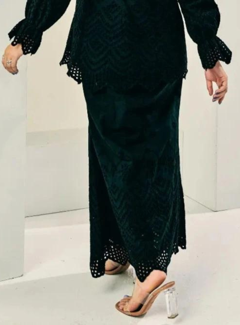 A woman wearing Black Ezzah Eyelet Doll Skirt