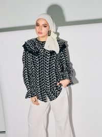A woman dressed in Black Maisara Eyelet Ruffles Top