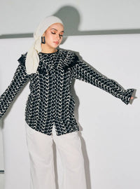A woman dressed in Black Maisara Eyelet Ruffles Top