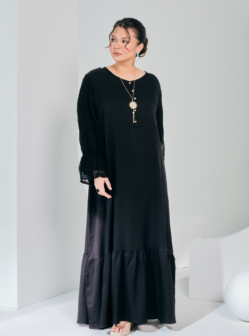 A woman dressed in Black Ms Wiwiana Maxi Dress with Long Elastic Princess Sleeves