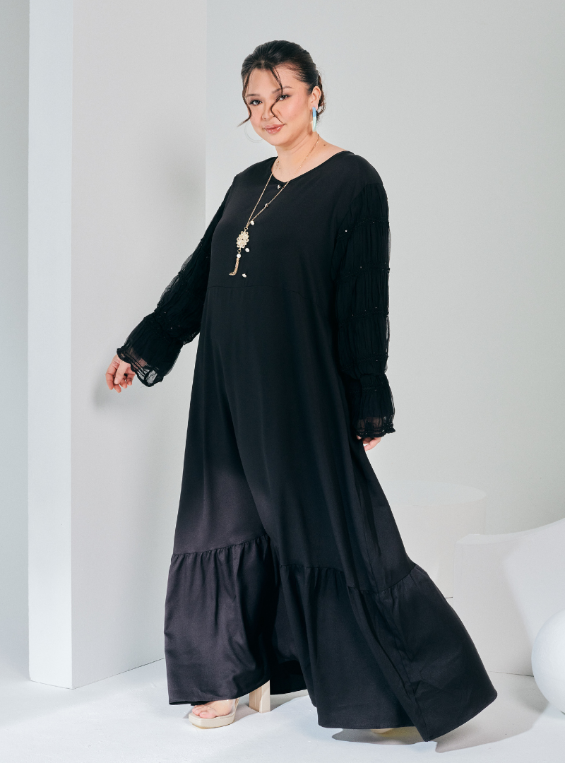 A woman dressed in Black Ms Wiwiana Maxi Dress with Long Elastic Princess Sleeves