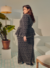 A woman dressed in Black Tun Rogayah Eyelet Peplum Kurung
