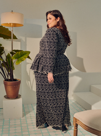 A woman dressed in Black Tun Rogayah Eyelet Peplum Kurung