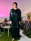 A woman dressed in Black Tun Seroja Satin Kurung Pahang