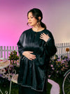 A woman dressed in Black Tun Seroja Satin Kurung Pahang