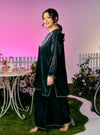 A woman dressed in Black Tun Seroja Satin Kurung Pahang