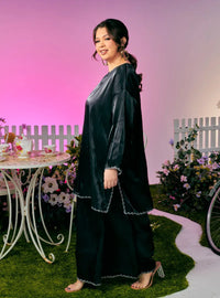 A woman dressed in Black Tun Seroja Satin Kurung Pahang