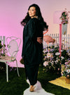 A woman dressed in Black Tun Yasmin Eyelet Oversized Kurung