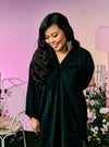 A woman dressed in Black Tun Yasmin Eyelet Oversized Kurung