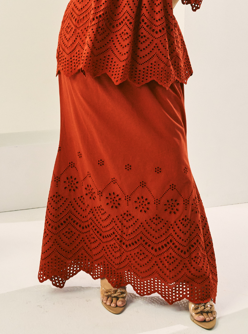 A woman wearing Brick Orange Ezzah Eyelet Doll Skirt