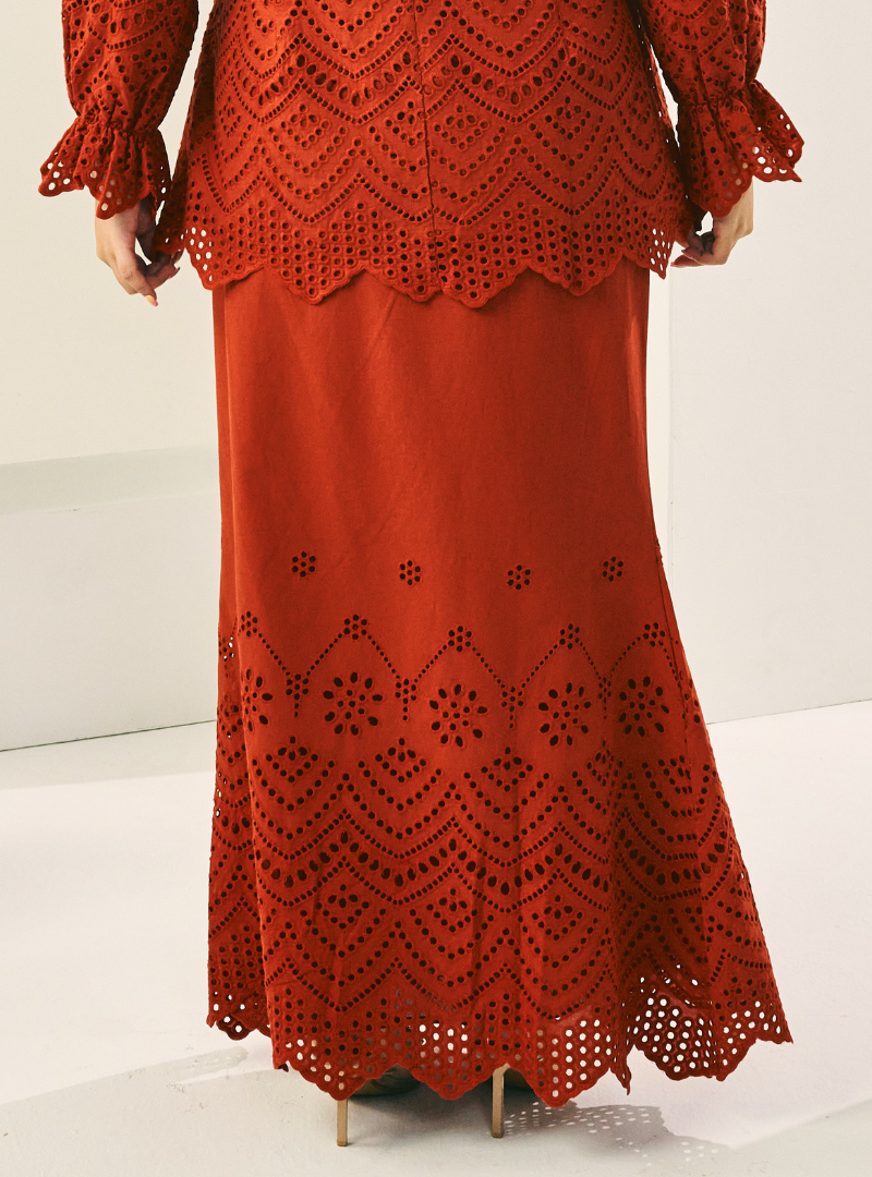 A woman wearing Brick Orange Ezzah Eyelet Doll Skirt