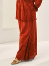 A woman wearing Brick Orange Ezzah Eyelet Doll Skirt