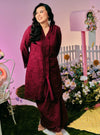 A woman dressed in Burgundy Maroon Tun Sabrina Eyelet Kebarung