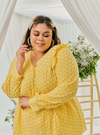 A woman dressed in Buttermilk Yellow Tun Natasha Eyelet Kurung Kedah Top