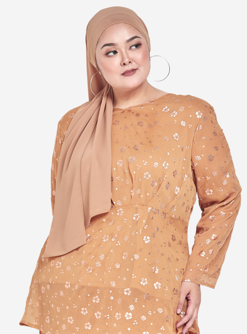 A woman dressed in Caramel Panca-Panca Printed Daisy