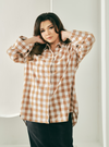 A woman dressed in Caramel Jennie Oversized Checked Cotton Shirts