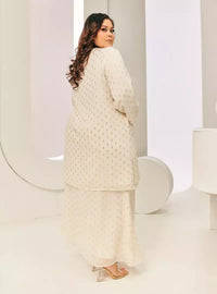 A woman dressed in Champagne Tun Tipah Dotted Wrap Kurung