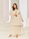 A woman dressed in Champagne Tun Tipah Dotted Wrap Kurung
