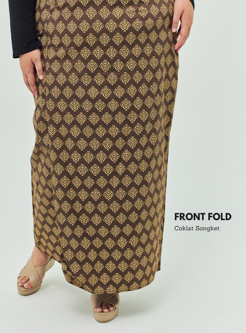 A woman dressed in Coklat Songket Front Fold Songket Skirt