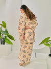 A woman dressed in Cream Corn Lily Vintage Opah Kurung