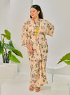 A woman dressed in Cream Corn Lily Vintage Opah Kurung