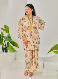 A woman dressed in Cream Corn Lily Vintage Opah Kurung