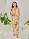 A woman dressed in Cream Corn Lily Vintage Opah Kurung