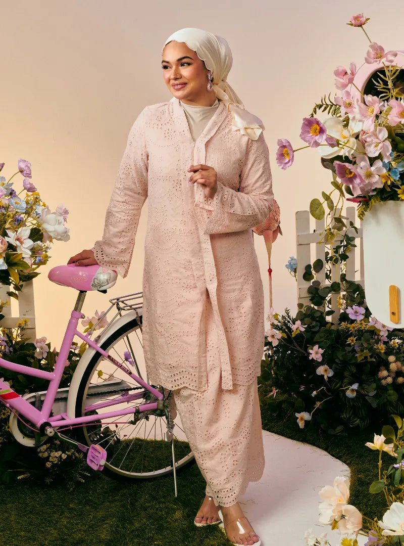 A woman dressed in Dusty Pink Tun Sabrina Eyelet Kebarung