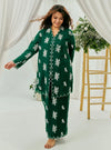 A woman dressed in Emerald Green Tun Saloma Klasik Kebaya Kurung