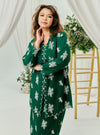 A woman dressed in Emerald Green Tun Saloma Klasik Kebaya Kurung