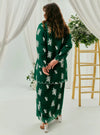 A woman dressed in Emerald Green Tun Saloma Klasik Kebaya Kurung