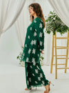 A woman dressed in Emerald Green Tun Saloma Klasik Kebaya Kurung