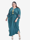 A woman dressed in Emerald Kak Ton Kaftan