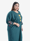 A woman dressed in Emerald Kak Ton Kaftan