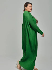 A woman dressed in Emerald Tun Aimellia Pleated Maxi Dress