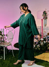 A woman dressed in Emerald Tun Yasmin Embroidered Eyelet Oversized Kurung