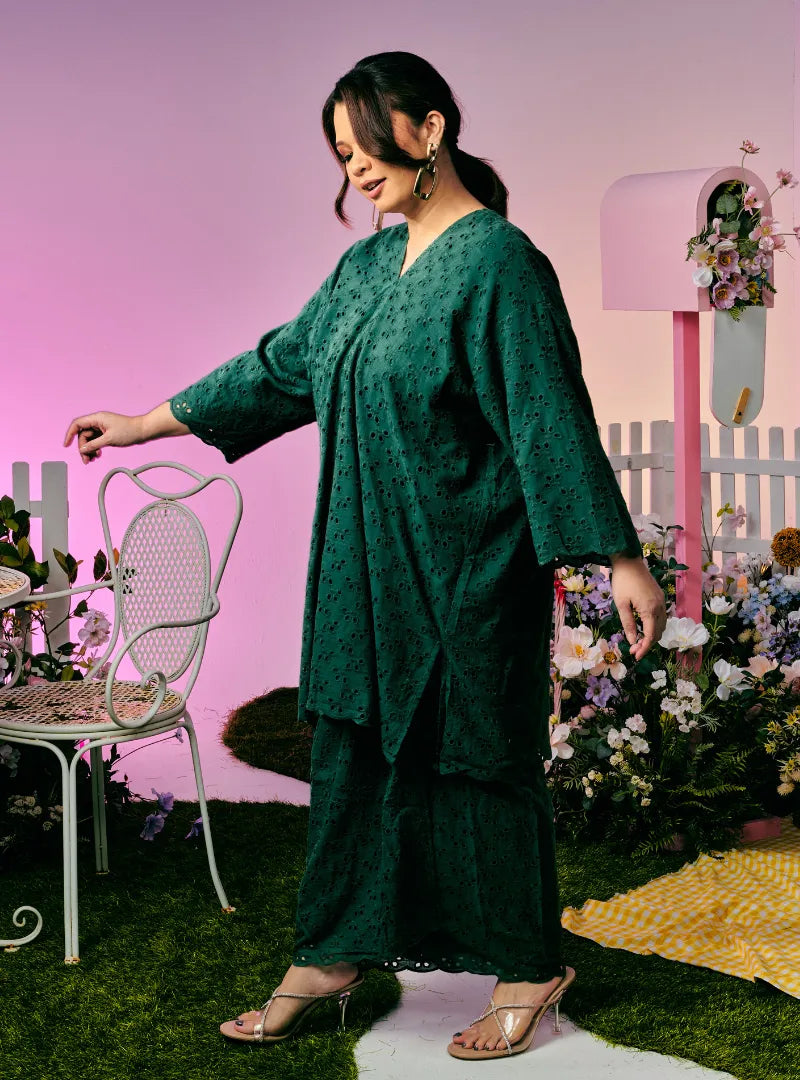 A woman dressed in Emerald Tun Yasmin Embroidered Eyelet Oversized Kurung