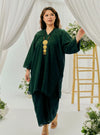 A woman dressed in Emerald Tun Yasmin Embroidered Eyelet Oversized Kurung