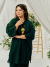 A woman dressed in Emerald Tun Yasmin Embroidered Eyelet Oversized Kurung