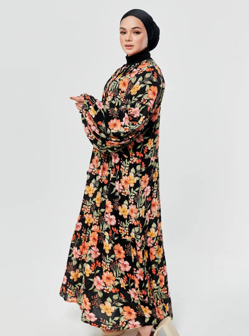 A woman dressed in Fleur Black The Bloom