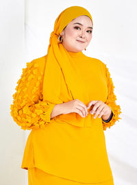 A woman dressed in Honey Mustard High Neck Butterfly Kurung