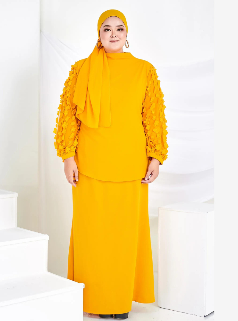A woman dressed in Honey Mustard High Neck Butterfly Kurung
