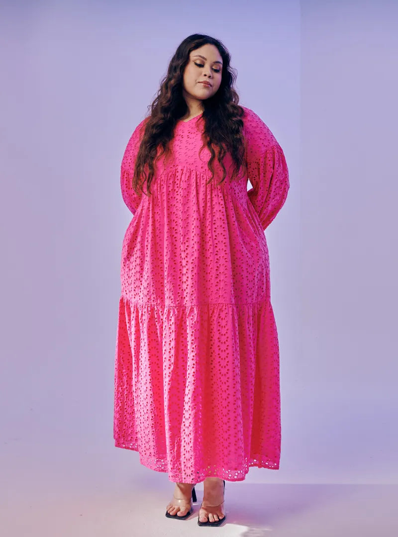 A woman dressed in Hot Pink Lola Cotton Eyelet Princess Dress