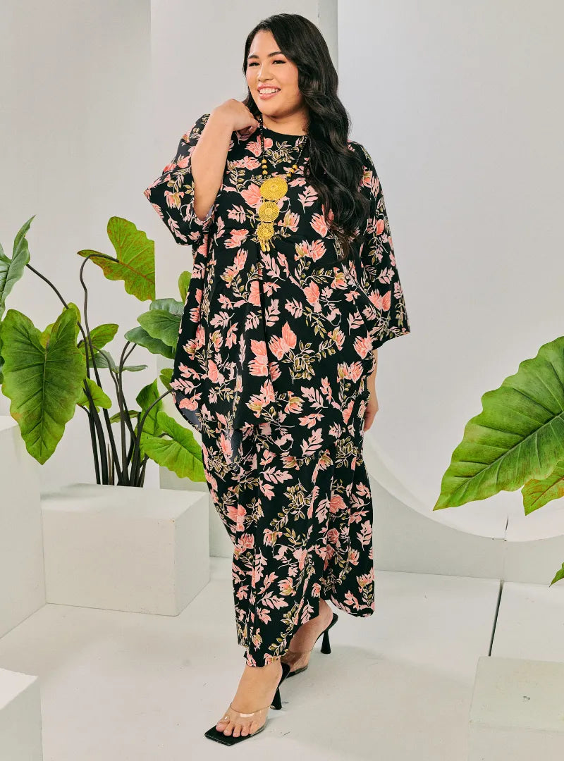 A woman dressed in Jowo Black The Vintage Opah Kurung