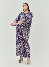 A woman dressed in Jowo Purple The Vintage Opah Kurung