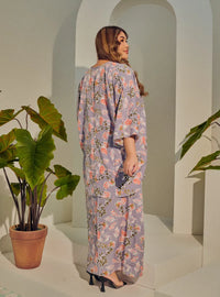 A woman dressed in Jowo Silver The Vintage Opah Kurung