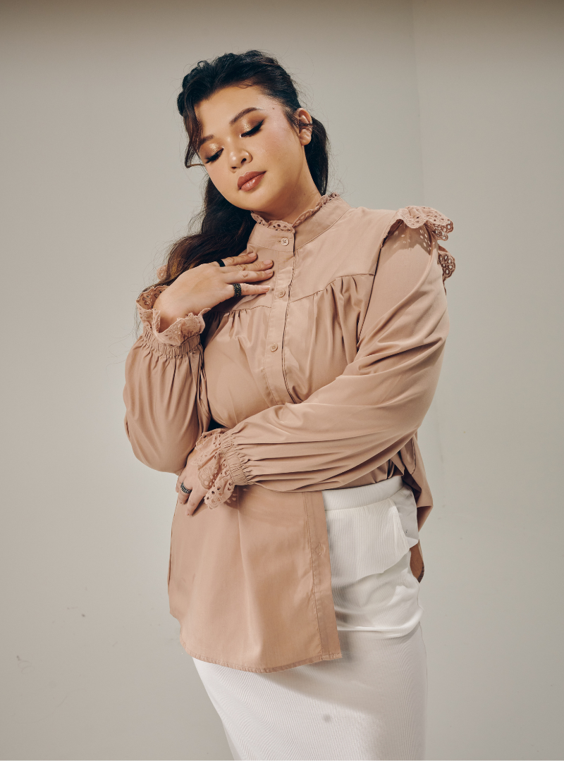 A woman dressed in Latte Mimi Cotton Broderie Ruffles